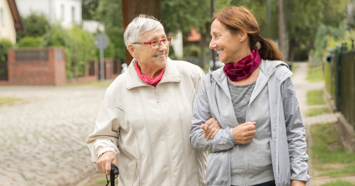 An adult daughter on a walk with her mother