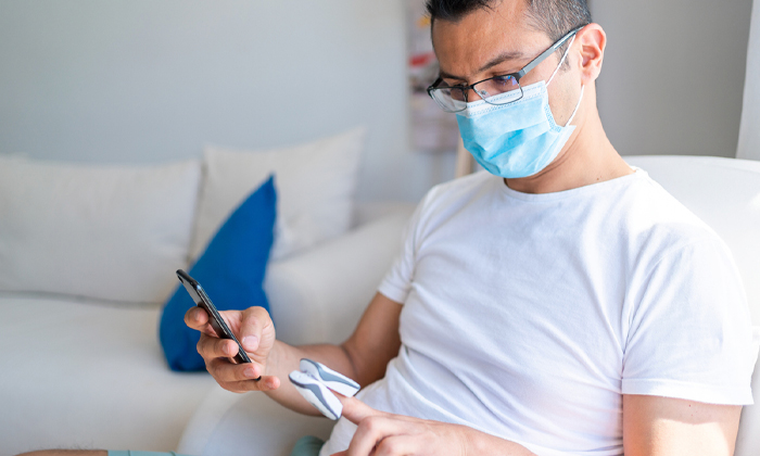 Man wearing face mask and testing oxygen levels