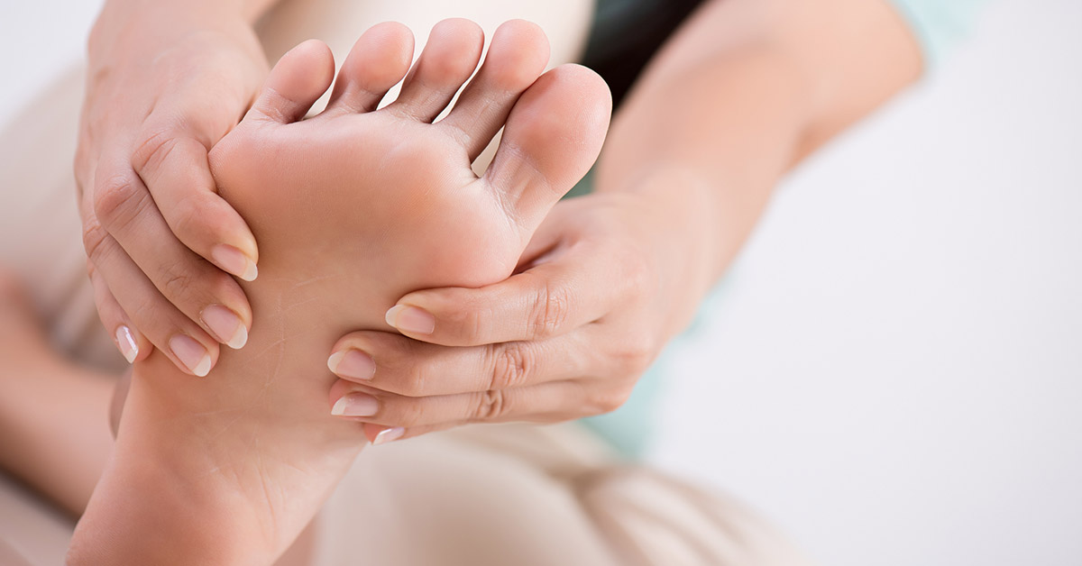 Close-up of women holding her foot