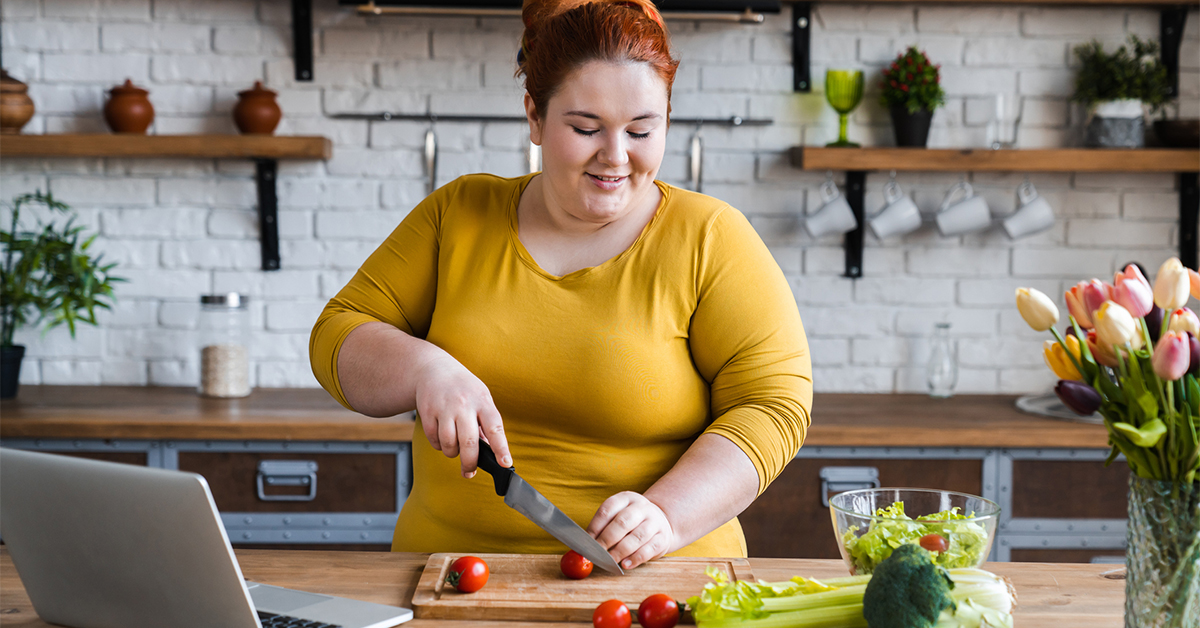 Woman in her kitchen making salad